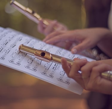 three women sitting on a bench in a park