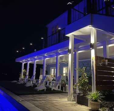 Modern backyard patio with luxury pool deck lighting and sconce lighting with speakers