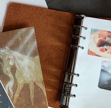 Flat lay of grid dot paper and photo stickers printed on labels in a pile of other journal-making materials.