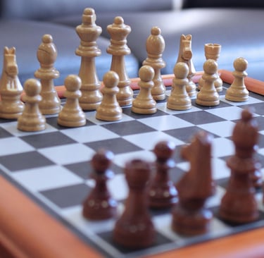 Handcrafted wooden chess set with Staunton style pieces on a classic checkered board.