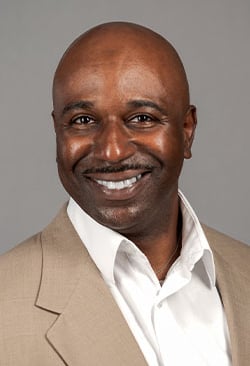 Louisiana business professional in a suit and white shirt poses for a headshot