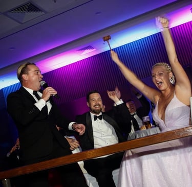 Professional benefit auctioneer Craig directing a high-stakes live auction at a Nashville luxury gal