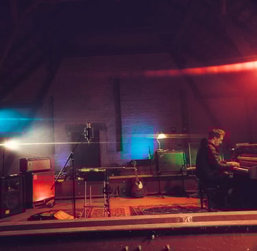 Live recording session with piano, amps and atmospheric lighting