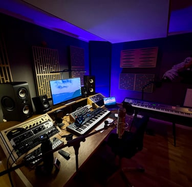 Professional music studio with synths, monitors and acoustic treatment
