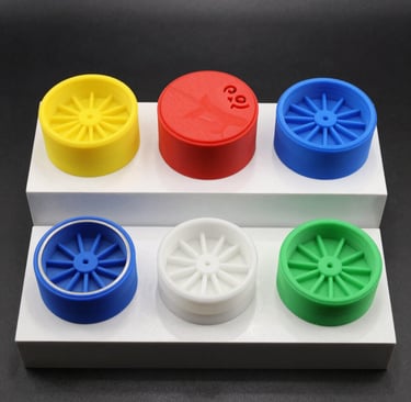 Colorful 3D printed stash containers arranged on a wooden table.