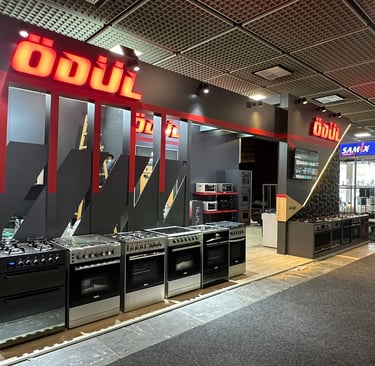 Professional industrial exhibit for kitchen appliances featuring dark aesthetic and functional product placement.