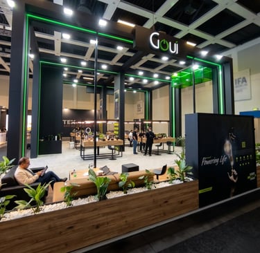 Sleek Goui exhibition booth design with black structure, green LED lighting accents, and interactive product displays.
