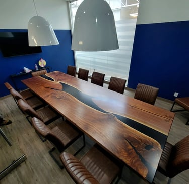12ft x 4ft black walnut black epoxy river boardroom table — installed view, built for Polaris