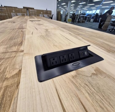 Integrated flush-mount power port in custom boardroom table — AC outlet, USB-A and USB-C
