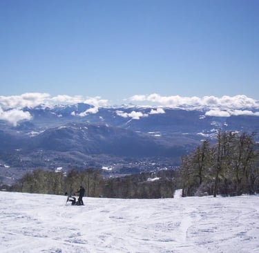 a person standing on a snowy mountain top chapelco argentina