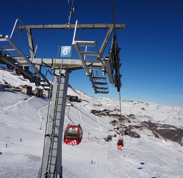 a ski lift going up a mountain with people on it valle nevado chile