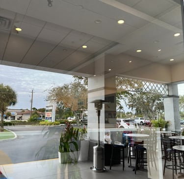 Commercial window cleaning services for a business storefront and patio in Naples, Florida.