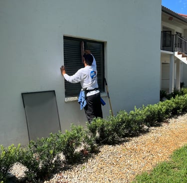 Professional residential window cleaning technician working on a home in Fort Myers, FL.