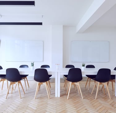 a table with chairs and a tv in a room