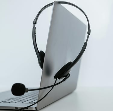 a laptop computer with a headset and a microphone