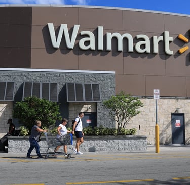 a group of people walking past a walmart store