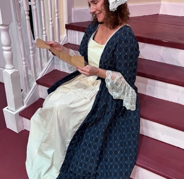 Actor posing as Abigail Adams reading a letter