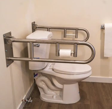 Accessible washroom in adult family home with grab bars, sink, and non-slip flooring.