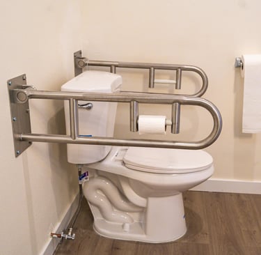 Accessible washroom in adult family home with grab bars, sink, and non-slip flooring.