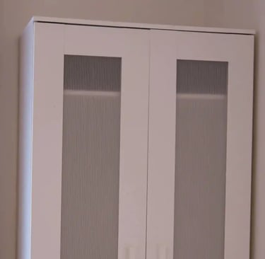 Built-in wardrobe in adult family home bedroom with shelves and hanging space for resident clothing.