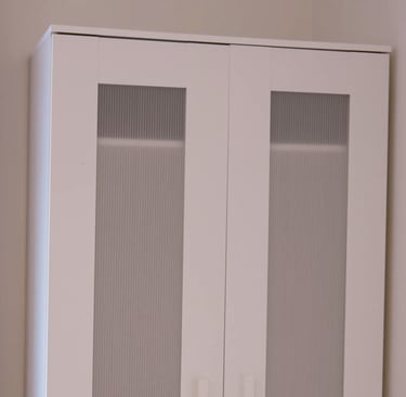 Built-in wardrobe in adult family home bedroom with shelves and hanging space for resident clothing.