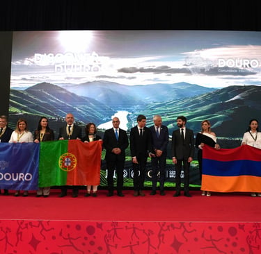 Dignitaries holding Portugal and Armenia flags at a Douro region tourism event.