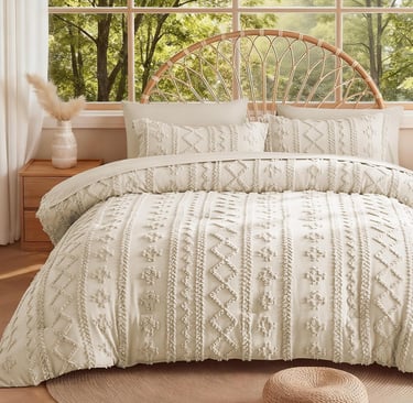 Boho chic cream tufted duvet cover set on a bed with a rattan headboard in a bright bedroom.