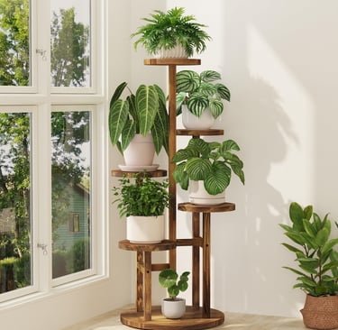 Multi-tier wooden plant stand with various potted indoor plants near a bright window.