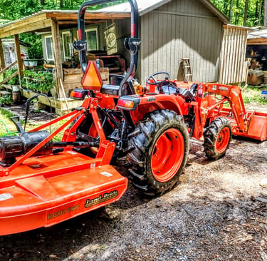 Tractor bush hogging field mower