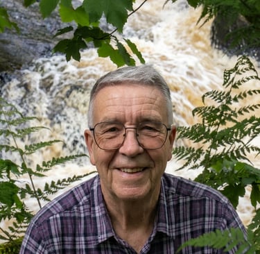 man stood above the Strid a fast flowing pint of the river Wharf at Bolto abbey woods. 