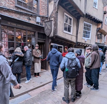 people waiting to in a shop  in the shambles in York