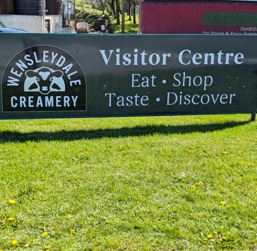 sign on the roadside at the entrance of the Wensleydale Creamery