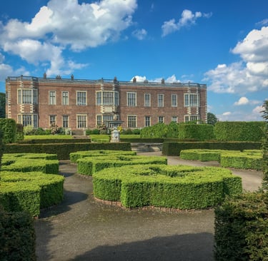 Temple newsham house, a big county house with hedge decoration in a garden, looks abit like a maze