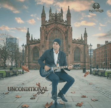 cover art of the single Unconditional. mANDRAk with a guitar in front of Manchester Cathedral