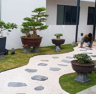 Bonsai garden installation at Laman Granview Selangor featuring potted trees and white gravel path.