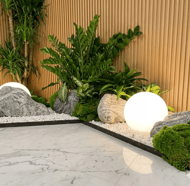 Indoor zen garden with glowing sphere light and decorative rocks – Yie Yang Landscape