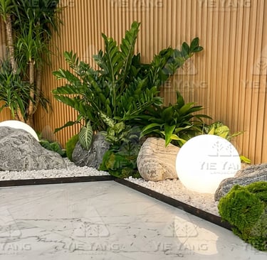 Indoor zen garden with glowing sphere light and decorative rocks – Yie Yang Landscape