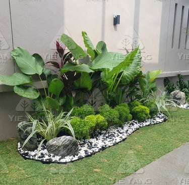 Tropical garden bed with white pebbles and artificial turf – Yie Yang Landscape