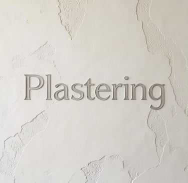 Professional plastering services displayed as gray text on a textured white interior wall.