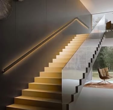 Modern floating staircase in wood with LED lighting in the handrail and glass railings in a luxuriou