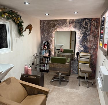 Modern interior of a hair salon with microcement finish, professional chairs, backlit mirrors and ha
