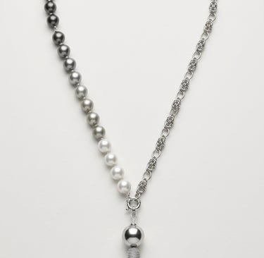 Elegant pearl and silver chain necklace featuring a gradient of grey pearls and a decorative silk tassel pendant.