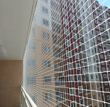 Wide shot of a rooftop fully covered with a safety net to prevent pigeons from nesting.