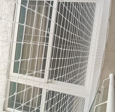 Pet safety netting secured on a window to prevent pets from slipping through gaps.