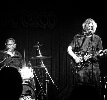 photo of guitarist and drummer playing