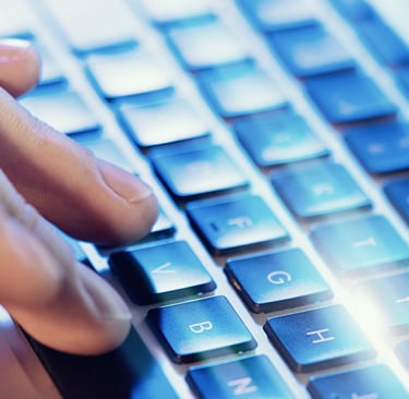 Fingers on a computer keyboard beginning to type