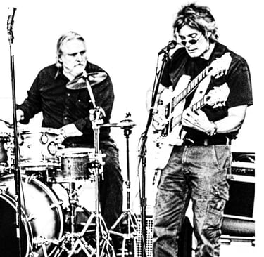 photo of guitarist and drummer playing