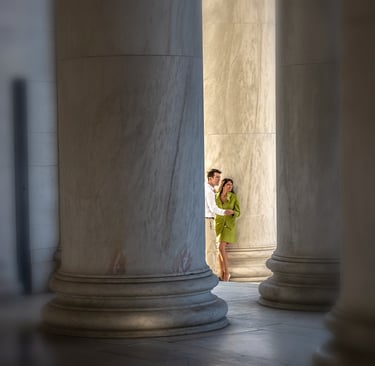 Photo of a couple seen between large columns