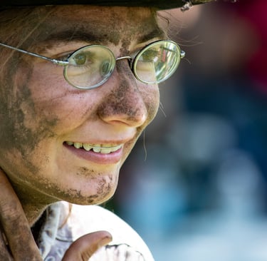 Photo of young woman with dirty face and hands
