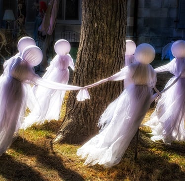 Photo of Halloween ghosts dancing around a tree